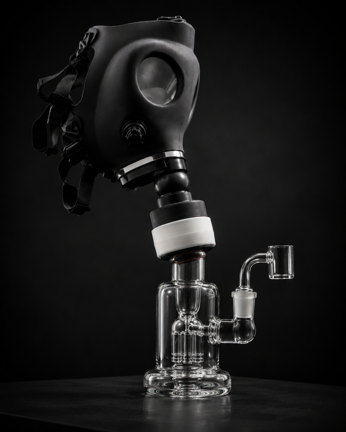 A gas mask hose connected through the Bong Bridge™ adapter to a glass water pipe on a wooden workbench